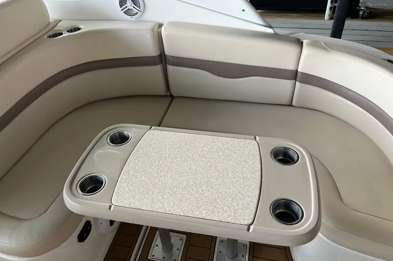 Slide: The Image of 2007 Chaparral 330 Signature boat interior with beige seating and table with cup holders. - 22