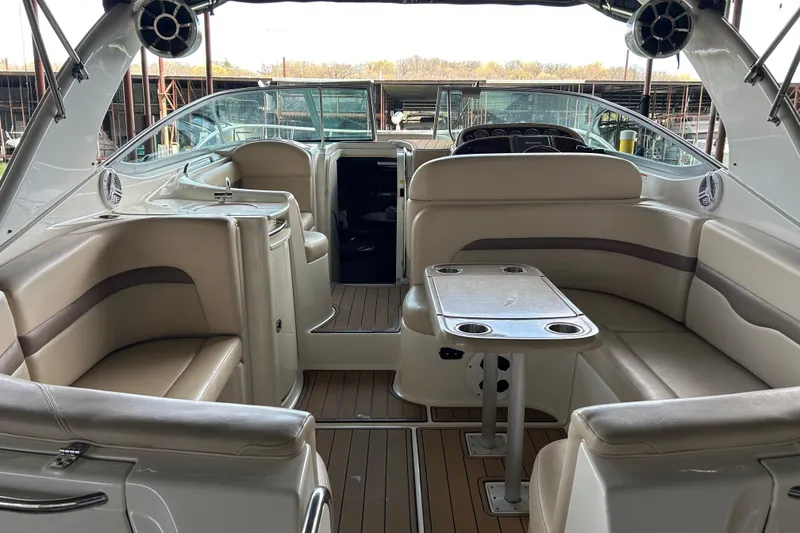 Slide: The Image of 2007 Chaparral 330 Signature boat interior with beige seating and wooden flooring. - 27