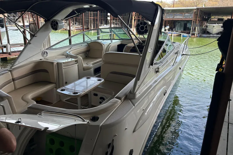 Slide: The Image of 2007 Chaparral 330 Signature boat docked, featuring spacious seating and sleek design. - 29