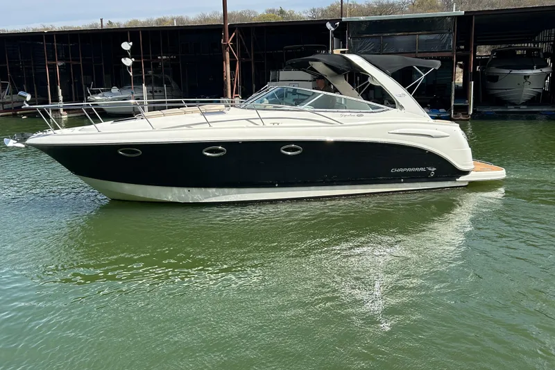 Slide: The Image of 2007 Chaparral 330 Signature boat docked on calm water, side view. - 5