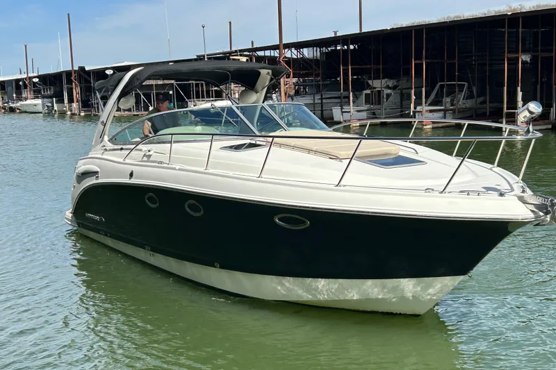 Slide: The Image of 2007 Chaparral 330 Signature boat docked in marina, featuring sleek design and spacious deck. - 6