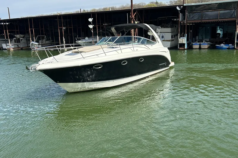 Slide: The Image of 2007 Chaparral 330 Signature boat docked on calm water near marina. - 7