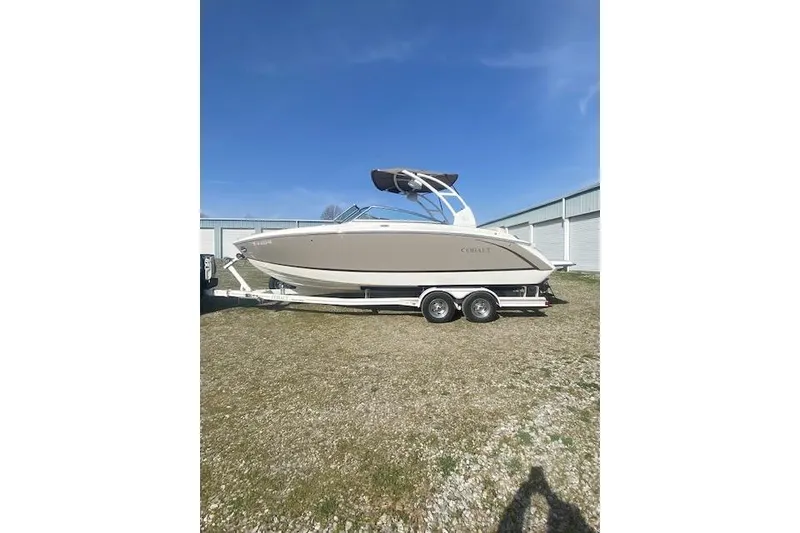 The Image of 2015 Cobalt R5 boat on trailer, parked outdoors under clear blue sky. - 0