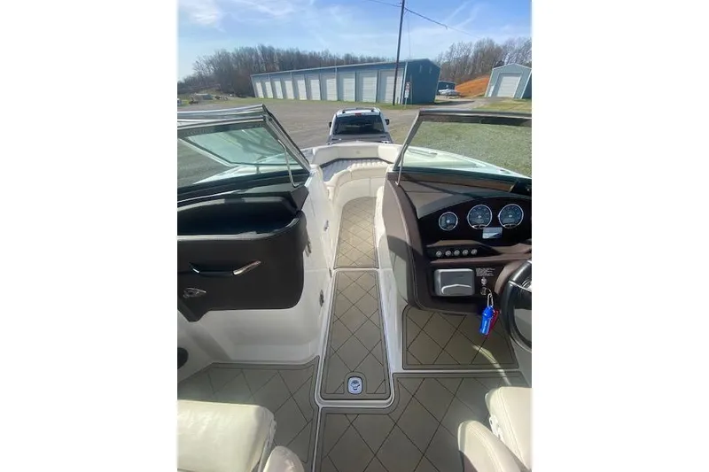 Slide: The Image of Interior view of a 2015 Cobalt R5 boat, showcasing dashboard and seating area. - 11