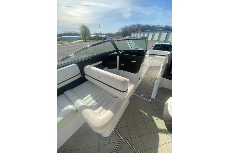 Slide: The Image of Interior of a 2015 Cobalt R5 boat with white seating and open deck. - 12