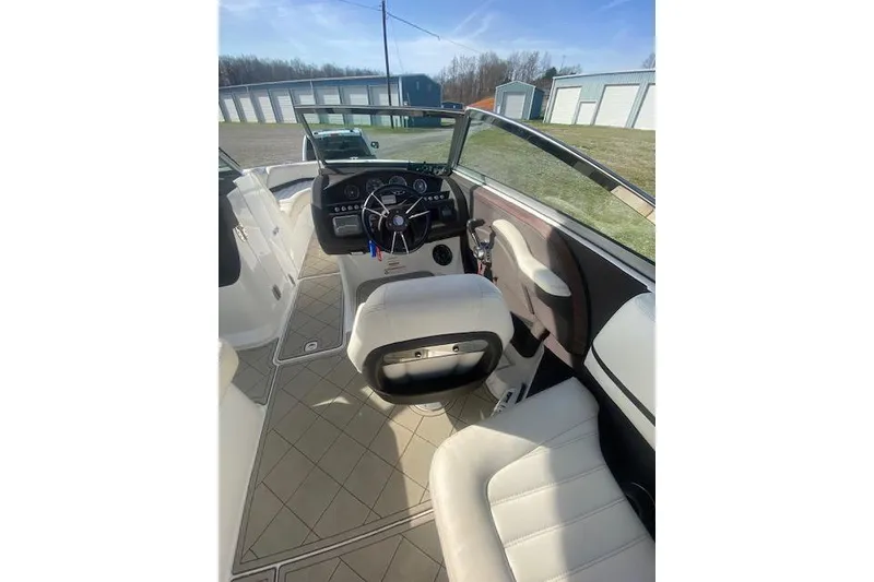 Slide: The Image of Interior of a 2015 Cobalt R5 boat with white seating and modern dashboard. - 13