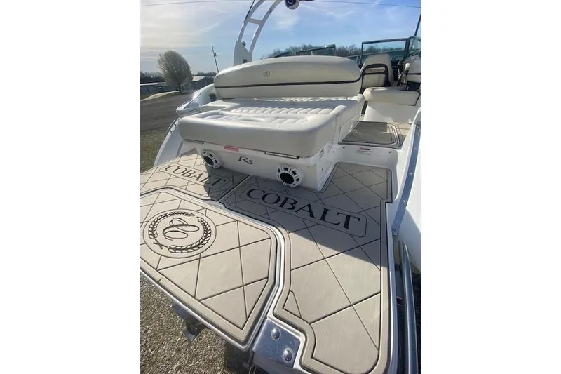 Slide: The Image of 2015 Cobalt R5 boat with cushioned seating and branded deck design. - 17