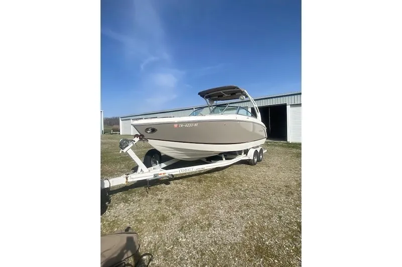 Slide: The Image of 2015 Cobalt R5 boat on trailer, parked outdoors under clear blue sky. - 21