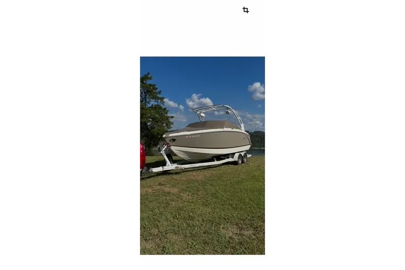 Slide: The Image of 2015 Cobalt R5 boat on trailer, parked on grassy area under blue sky. - 22