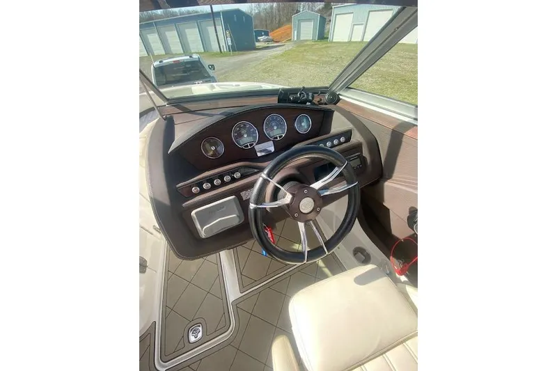 Slide: The Image of Steering wheel and dashboard of a 2015 Cobalt R5 boat, featuring gauges and controls. - 3