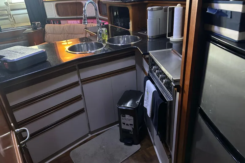 Slide: The Image of 1989 Carver 380 Santego yacht interior with seating area and covered deck. - 10