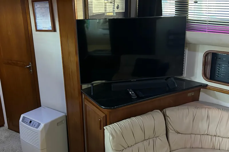 Slide: The Image of Cozy interior of 1989 Carver 380 Santego yacht with plush seating and ambient lighting. - 17