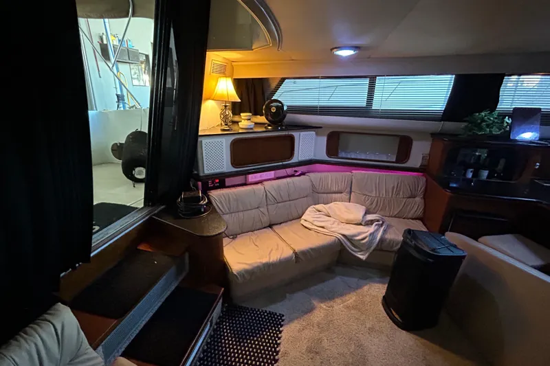 Slide: The Image of Open pantry with shelves, paper towels, and various household items on a Carver 380 Santego boat. - 19