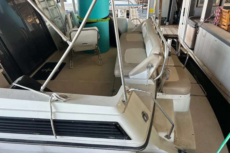 Slide: The Image of 1989 Carver 380 Santego yacht on calm water, featuring a spacious deck and canopy. - 2