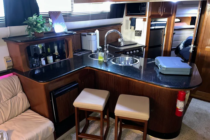 Slide: The Image of Kitchen area of a 1989 Carver 380 Santego yacht with sink, stove, and fridge. - 20