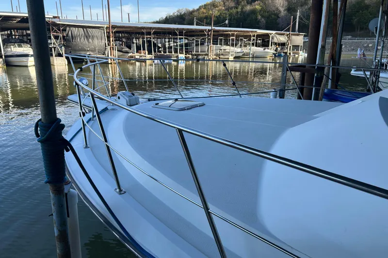 Slide: The Image of 1989 Carver 380 Santego yacht docked in marina, featuring sleek design and American flag. - 3