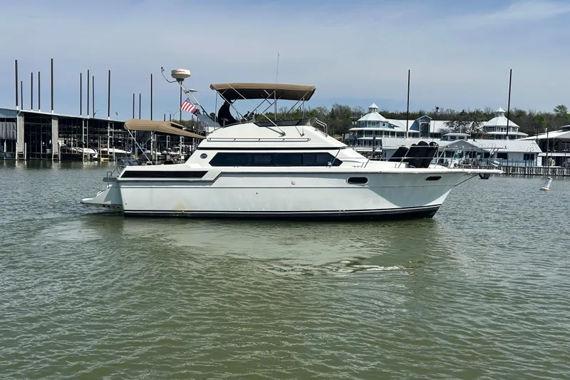 Slide: The Image of 1989 Carver 380 Santego yacht docked in a marina, featuring a sleek white design. - 35