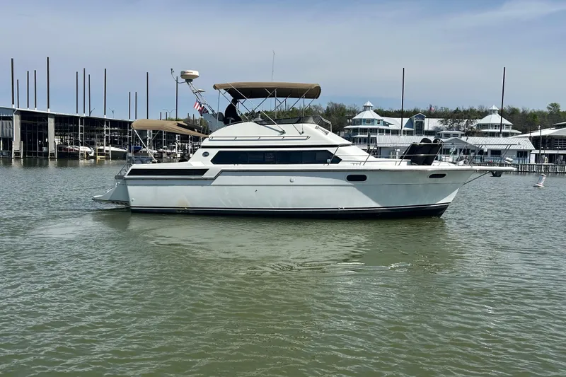 Slide: The Image of 1989 Carver 380 Santego yacht docked in a marina, calm waters, clear sky. - 36