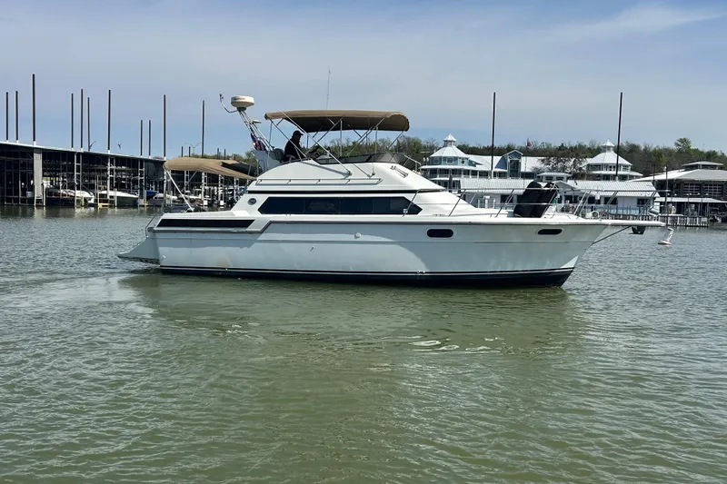 Slide: The Image of 1989 Carver 380 Santego yacht docked in a marina, calm waters, clear sky. - 37