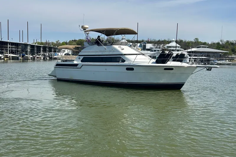 Slide: The Image of 1989 Carver 380 Santego yacht docked in a marina, calm waters, clear sky. - 38