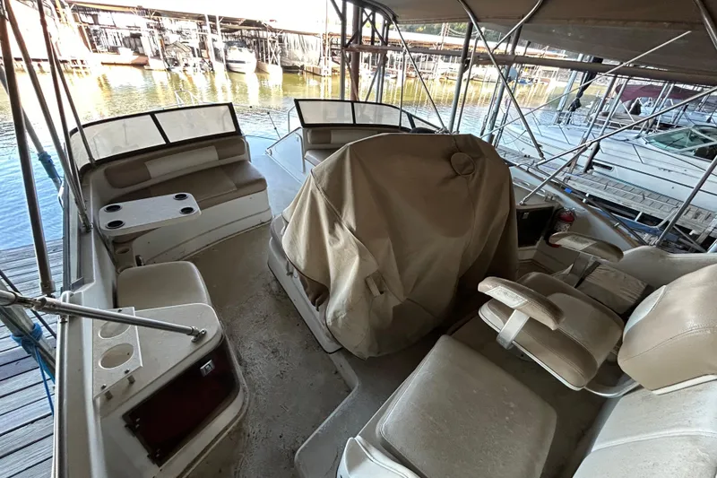 Slide: The Image of 1989 Carver 380 Santego yacht docked in a marina with kayaks nearby. - 5