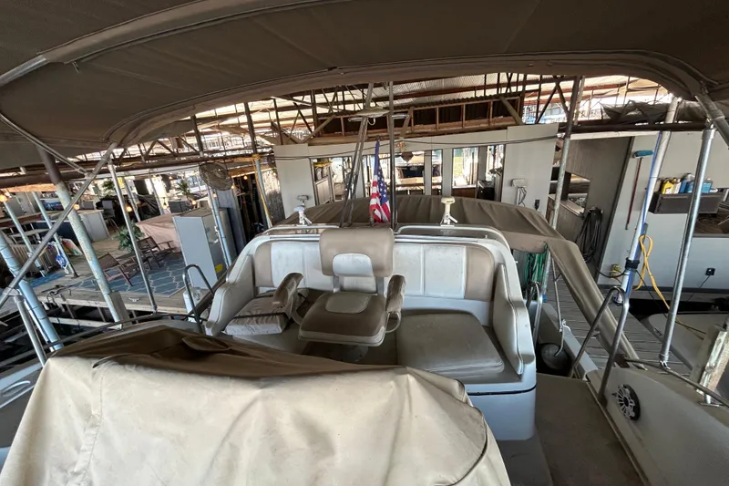 Slide: The Image of 1989 Carver 380 Santego boat interior with seating and dock view. - 6