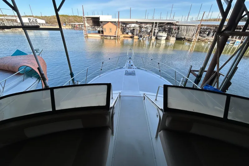 Slide: The Image of 1989 Carver 380 Santego yacht docked at a marina, showcasing sleek deck design. - 7