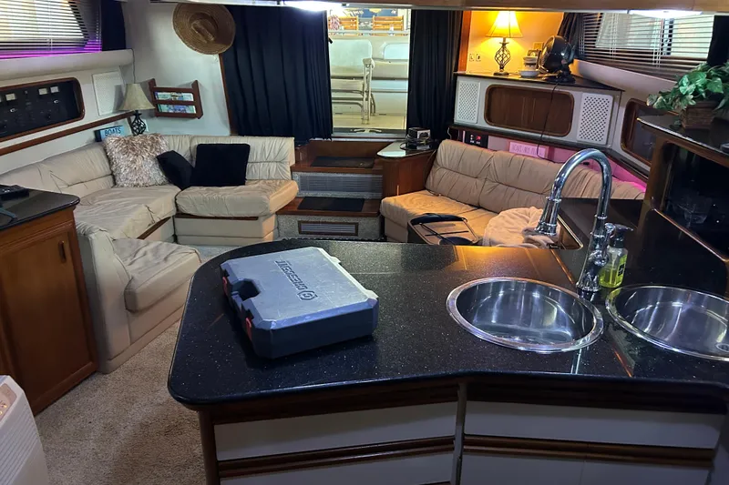 Slide: The Image of 1989 Carver 380 Santego boat interior with seating and covered helm, docked at marina. - 9