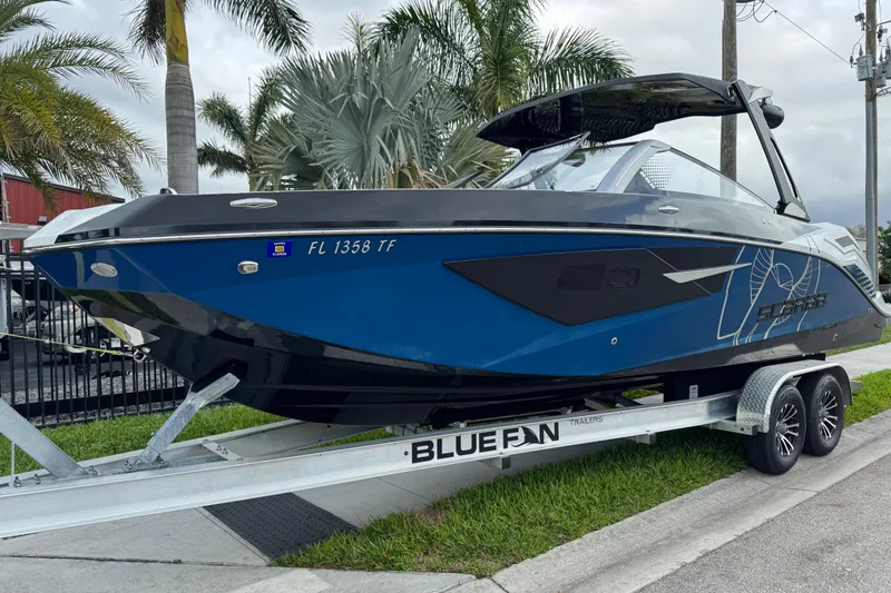 The Image of 2022 Scarab 285 ID boat on trailer, parked near palm trees. - 0