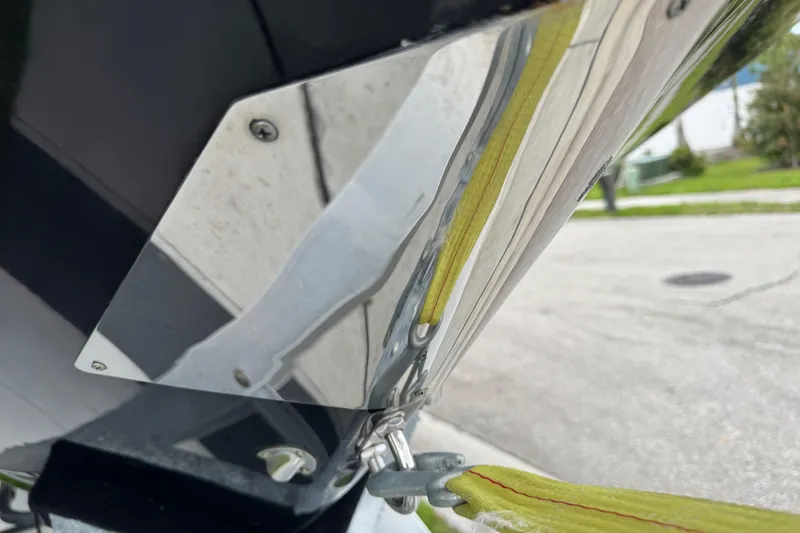 Slide: The Image of Close-up of 2022 Scarab 285 ID boat hull with metal fittings and yellow strap. - 10