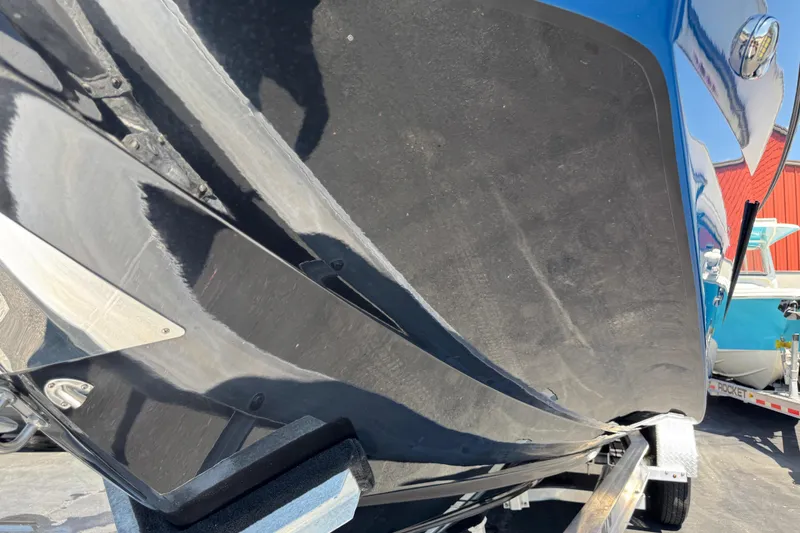 Slide: The Image of 2022 Scarab 285 ID boat hull on trailer, showcasing sleek design and glossy finish. - 102