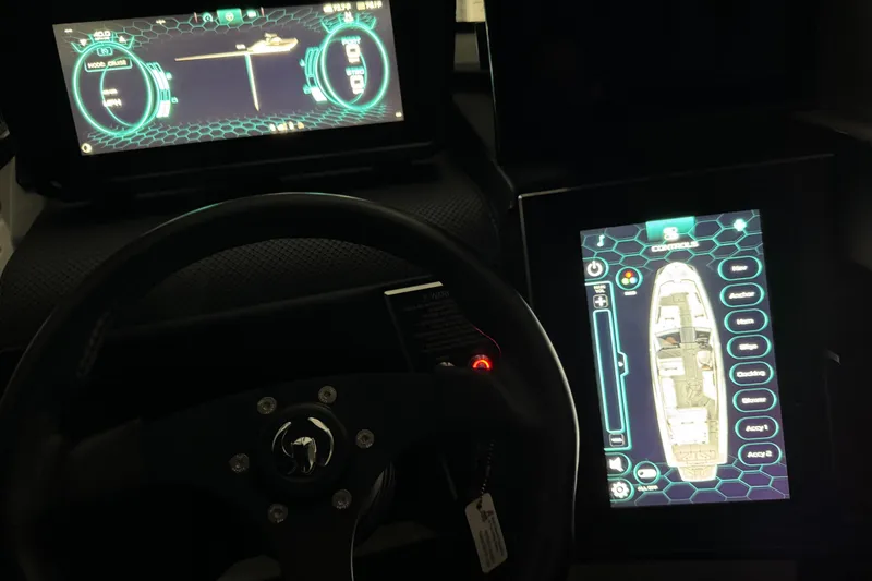Slide: The Image of 2022 Scarab 285 ID dashboard with digital displays and steering wheel. - 104