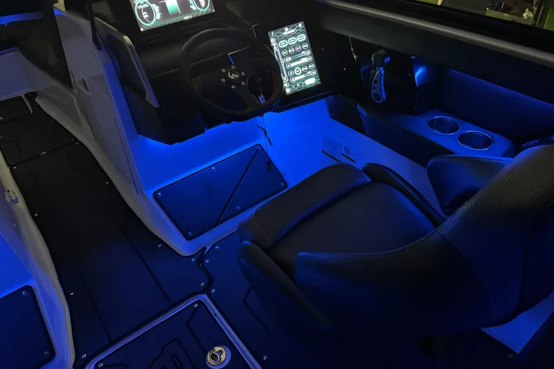 Slide: The Image of 2022 Scarab 285 ID boat interior with blue ambient lighting and modern dashboard. - 106