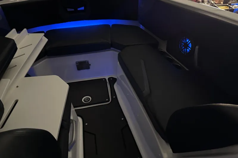Slide: The Image of 2022 Scarab 285 ID boat interior with blue LED lighting and cushioned seating. - 107