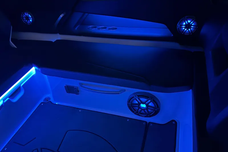 Slide: The Image of Interior of 2022 Scarab 285 ID boat with blue LED lighting and speakers. - 110