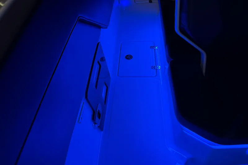 Slide: The Image of 2022 Scarab 285 ID boat interior illuminated with blue LED lighting. - 111