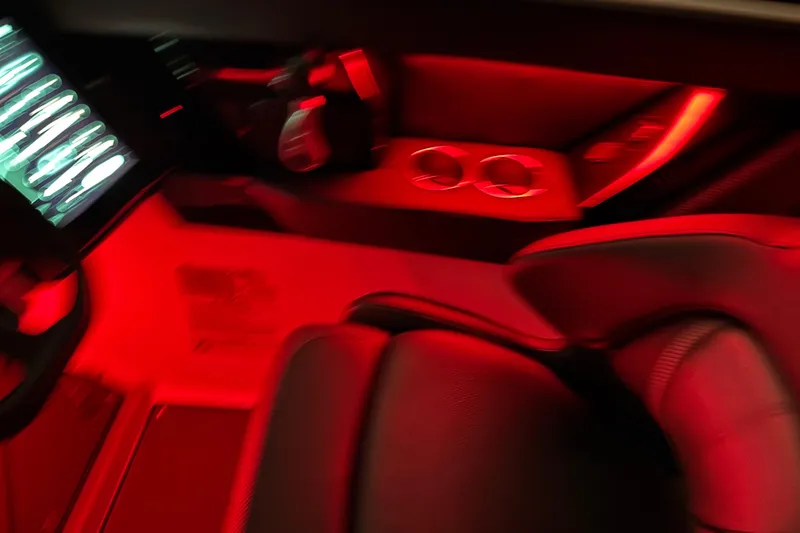 Slide: The Image of 2022 Scarab 285 ID interior with red ambient lighting and modern controls. - 117