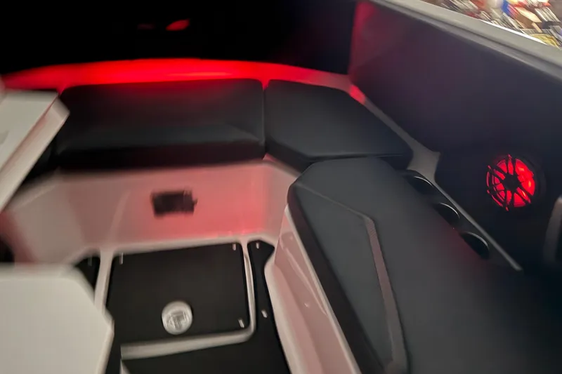 Slide: The Image of Interior of 2022 Scarab 285 ID boat with red ambient lighting and cushioned seating. - 118