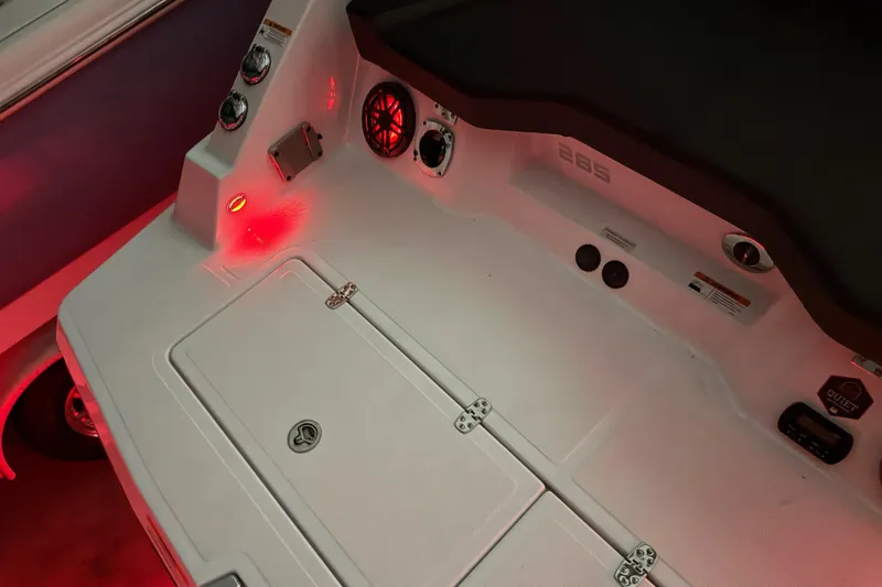 Slide: The Image of 2022 Scarab 285 ID boat interior with red ambient lighting and control panel. - 124