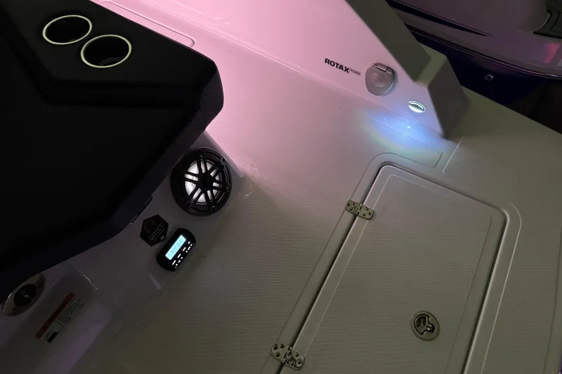 Slide: The Image of Interior of 2022 Scarab 285 ID boat with speaker, control panel, and storage compartment. - 136