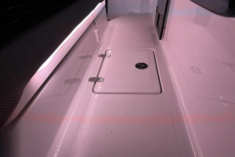 Slide: The Image of 2022 Scarab 285 ID boat interior with storage compartment and sleek design. - 137