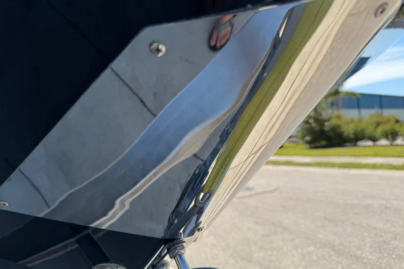 Slide: The Image of Close-up of a 2022 Scarab 285 ID boat's polished metal surface reflecting surroundings. - 17