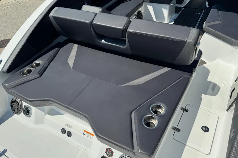 Slide: The Image of 2022 Scarab 285 ID boat interior with cushioned seating and cup holders. - 21