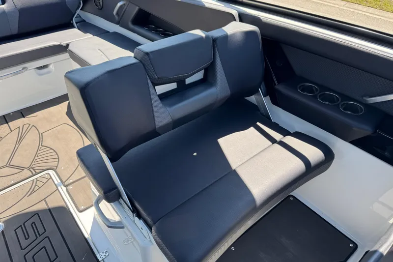 Slide: The Image of 2022 Scarab 285 ID boat interior with black seating and cup holders. - 24