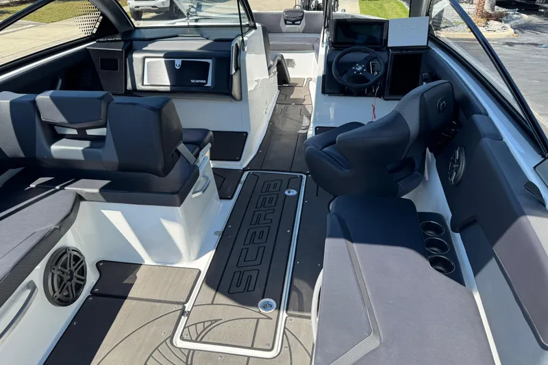 Slide: The Image of 2022 Scarab 285 ID boat interior with modern seating and dashboard design. - 27