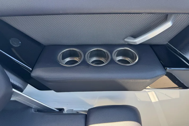 Slide: The Image of 2022 Scarab 285 ID boat interior with three stainless steel cup holders. - 28