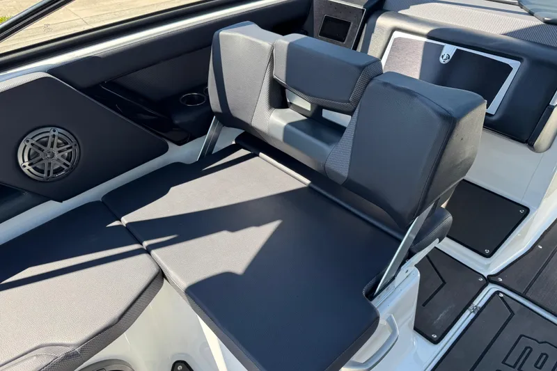 Slide: The Image of 2022 Scarab 285 ID boat interior with black seating and speaker detail. - 32