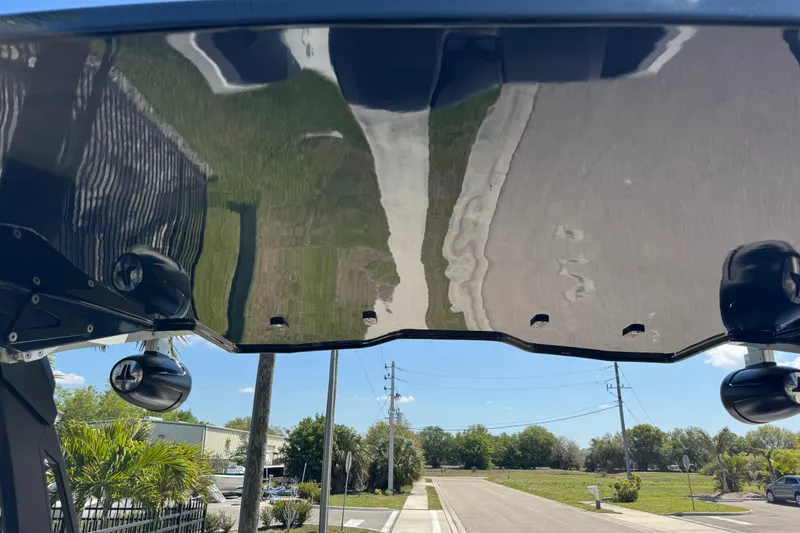 Slide: The Image of 2022 Scarab 285 ID boat with sleek black hull and scenic background. - 36