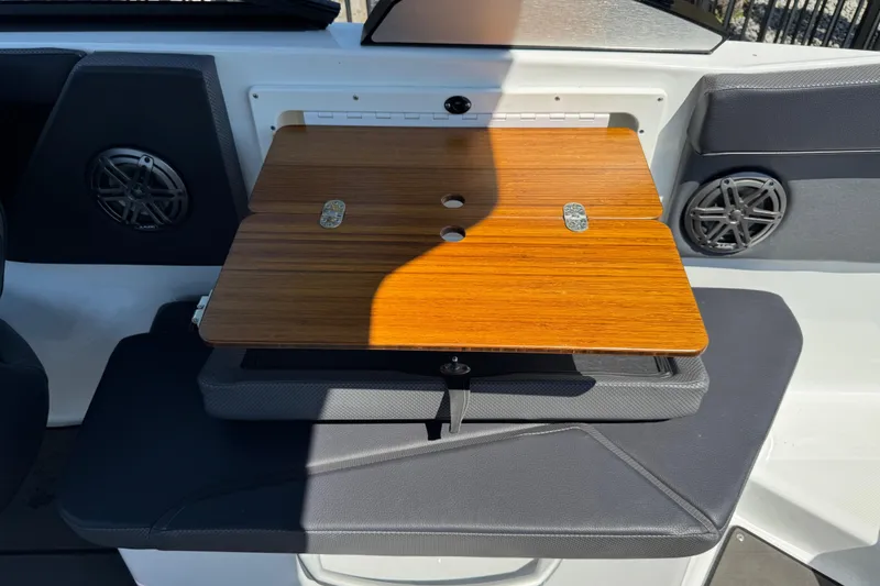 Slide: The Image of 2022 Scarab 285 ID boat interior with wooden table and speaker system. - 40