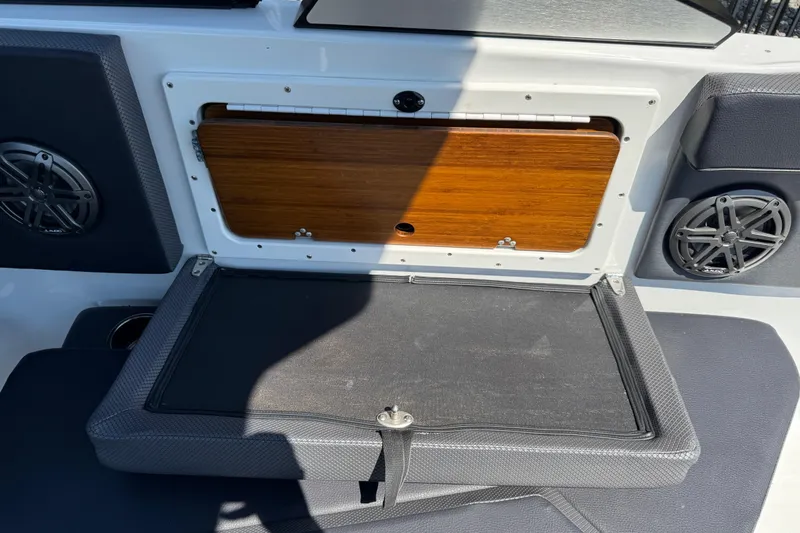 Slide: The Image of 2022 Scarab 285 ID boat interior with storage compartment and speakers. - 41